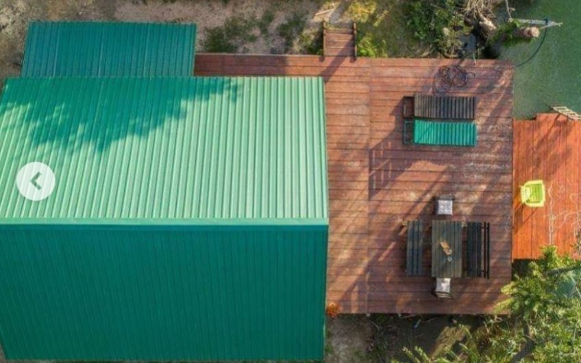 Two-storey wooden house with large terrace on riverbank in Ada Bojana